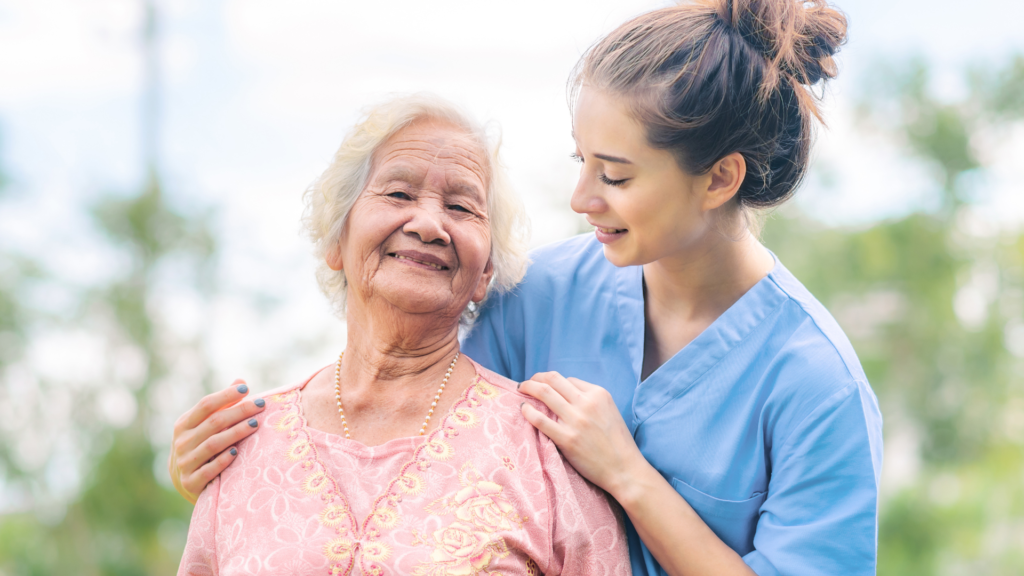 Old woman smiling with female caregiver
