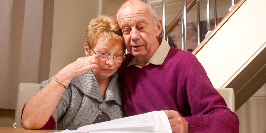 an elder couple studying their financial options for assisted living